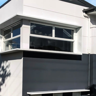 Corner window shroud on a modern house in Pearl White