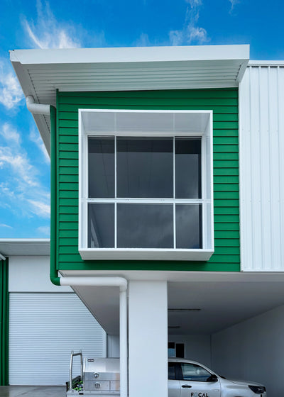 White Window Box on Green Building