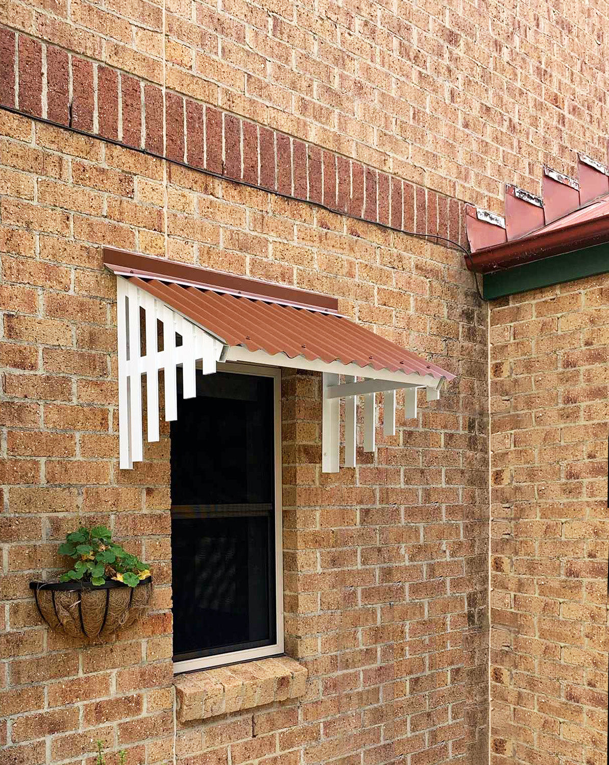 Window Hood with COLORBOND® Terrain Roofing and Surfmist Battens installed on a brick house