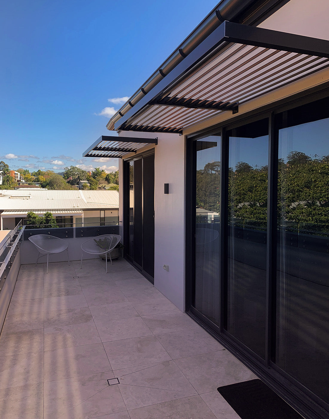 Slat awnings over a balcony